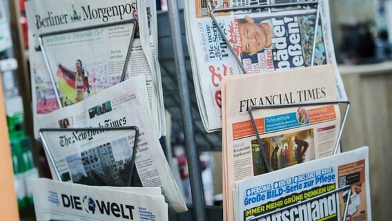 Verschiedene Zeitungen stecken in einem Zeitungsständer © picture alliance/dpa Foto: Annette Riedl